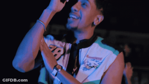 Man Singing Into Microphone In Manchester Shirt GIF