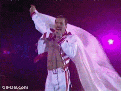 Man Singing Into Microphone In White Robe GIF