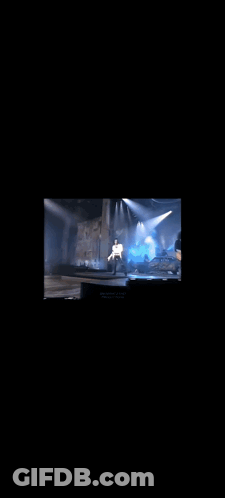 Man Singing Into Microphone In White Shirt GIF