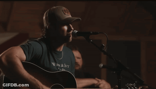 Man Singing Into Microphone In WRN & Ivy Shirt GIF