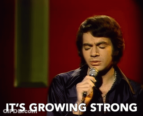 Man Singing Into Microphone It's Growing Strong GIF
