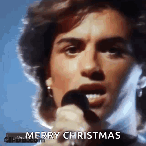 Man Singing Into Microphone Merry Christmas GIF