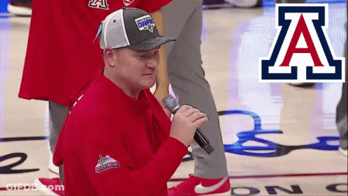 Man Singing Into Microphone On Basketball Court With Letter A GIF