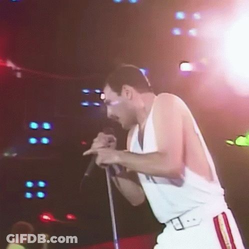 Man Singing Into Microphone On Stage GIF