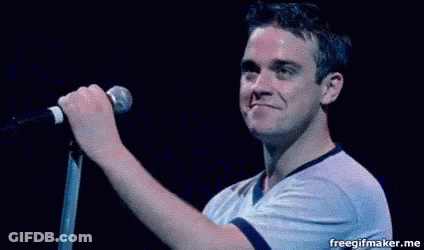 Man Singing Into Microphone On Stage GIF