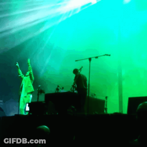 Man Singing Into Microphone On Stage GIF