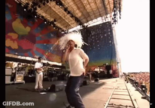 Man Singing Into Microphone On Stage GIF