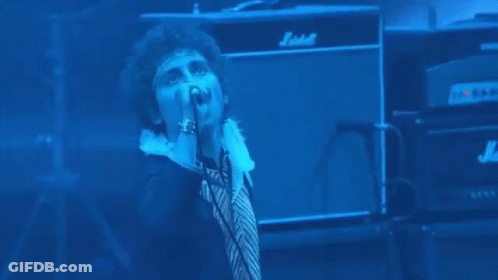 Man Singing Into Microphone On Stage GIF