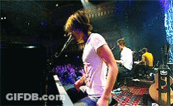 Man Singing Into Microphone On Stage GIF
