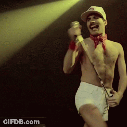 Man Singing Into Microphone On Stage GIF