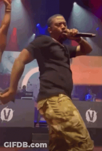 Man Singing Into Microphone On Stage GIF