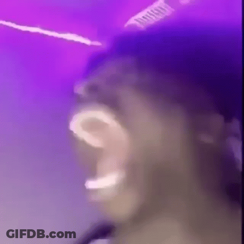Man Singing Into Microphone Playing Drums GIF