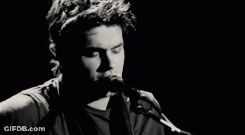 Man Singing Into Microphone Playing Guitar GIF