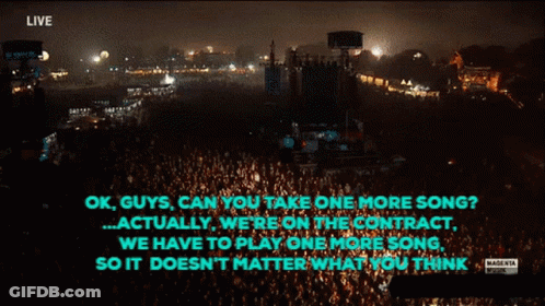 Man Singing Into Microphone Playing Guitar And Drums GIF