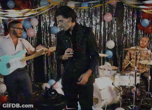 Man Singing Into Microphone Playing Guitar With Balloons GIF