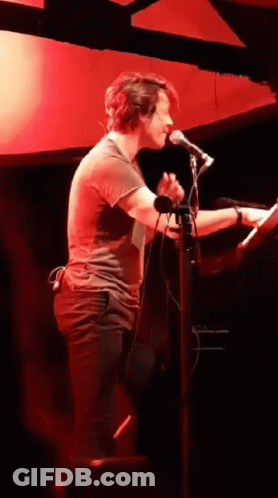 Man Singing Into Microphone Playing Keyboard GIF