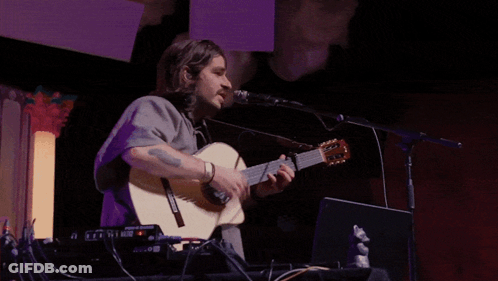 Man Singing Into Microphone Playing Yamaha Guitar GIF