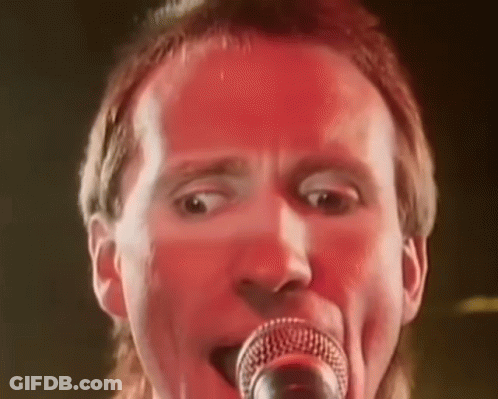 Man Singing Into Microphone Red Background GIF
