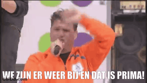 Man Singing Into Microphone We Zijn Er Weer Bij En Dat Is Prima GIF