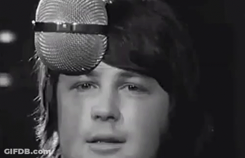 Man Singing Into Microphone Wearing Hat GIF
