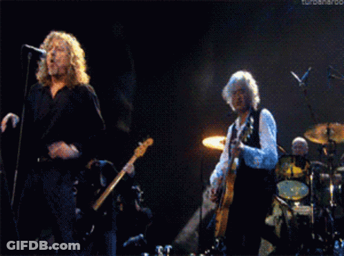 Man Singing Into Microphone While Man Plays Guitar GIF