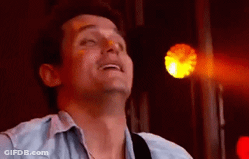 Man Singing Into Microphone While Playing Guitar GIF