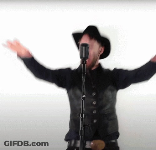 Man Singing Into Microphone With Arms Outstretched GIF