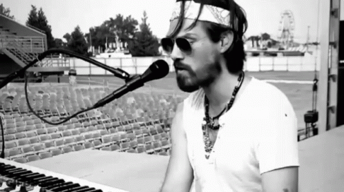 Man Singing Into Microphone With Bandana GIF