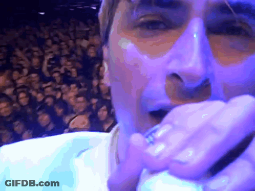 Man Singing Into Microphone With Crowd GIF