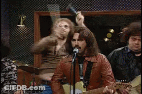 Man Singing Into Microphone With Drummer GIF