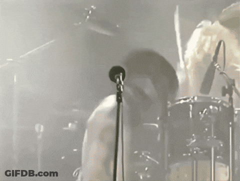 Man Singing Into Microphone With Drummer GIF