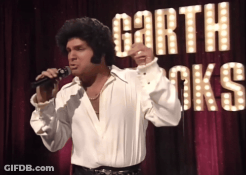 Man Singing Into Microphone With Garth Brooks Sign GIF