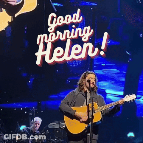Man Singing Into Microphone With Good Morning Helen Sign GIF