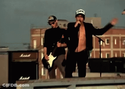 Man Singing Into Microphone With Guitarist GIF