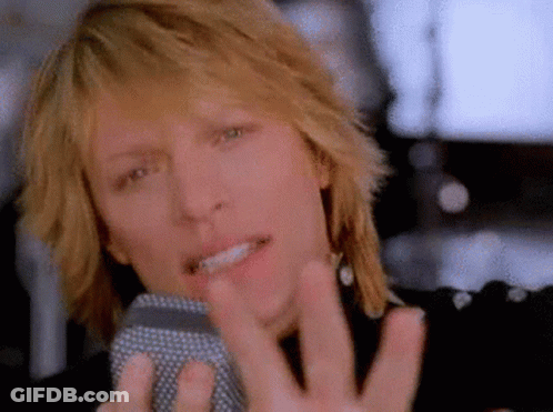 Man Singing Into Microphone With Hand Outstretched GIF