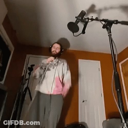 Man Singing Into Microphone With Headphones GIF