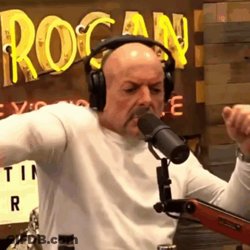 Man Singing Into Microphone With Headphones GIF