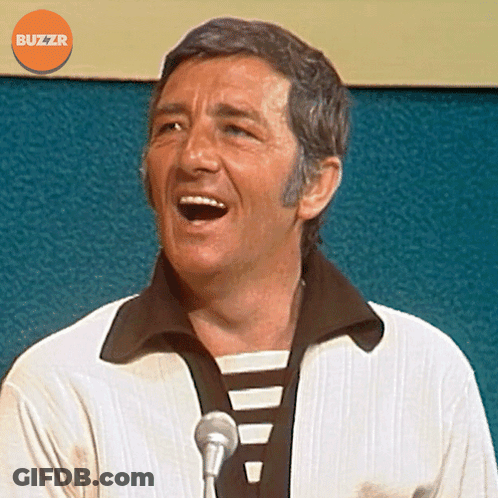 Man Singing Into Microphone With Orange Buzzr Logo GIF