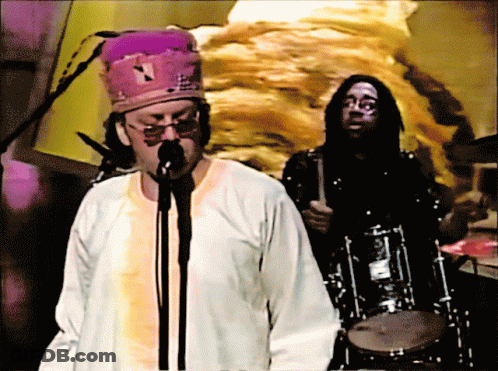 Man Singing Into Microphone With Purple Hat GIF