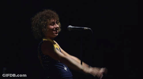 Man Singing Into Microphone With Star Shirt GIF