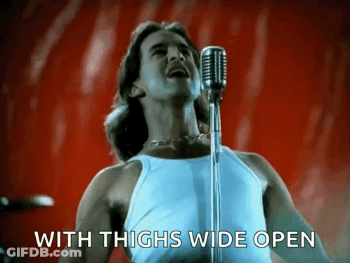 Man Singing Into Microphone With Thighs Wide Open GIF