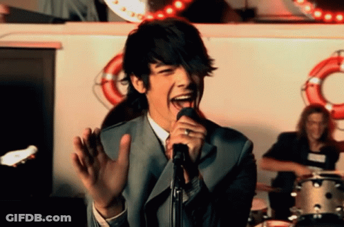 Man Singing Into Microphone With Tongue Out GIF