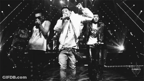 Man Singing Into Microphone With Two Men Dancing Behind GIF