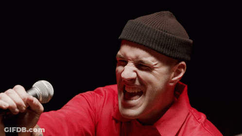 Man Singing Microphone In Red Shirt Black Beanie GIF