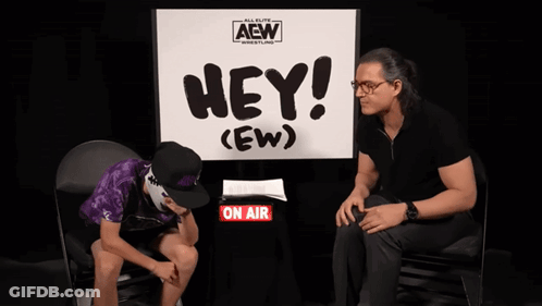 Man Sits In Front Of Sign Saying Hey (Ew) GIF