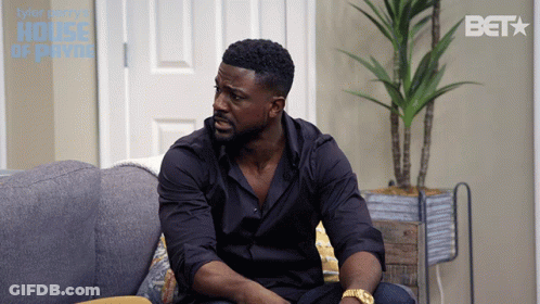 Man Sits On Couch With BET Logo GIF