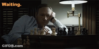 Man Sitting At Chess Table Saying Waiting GIF