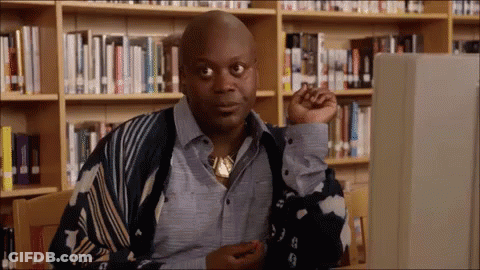 Man Sitting At Computer In Library GIF