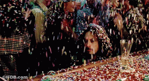 Man Sitting At Confetti Covered Table GIF