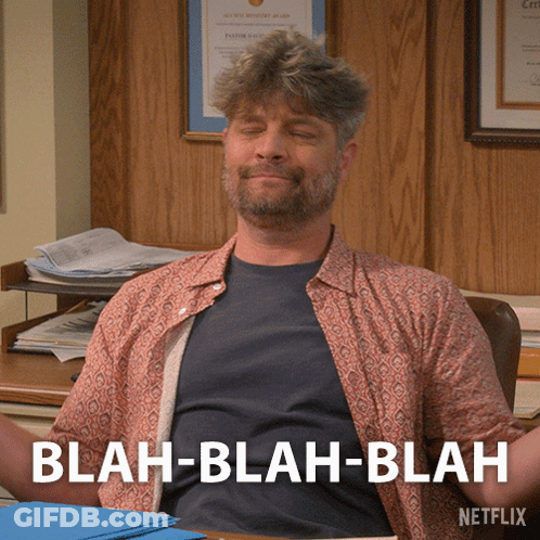 Man Sitting At Desk Eyes Closed Saying Blah Blah Blah GIF